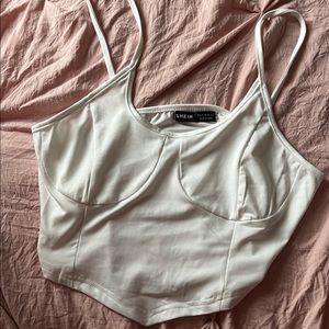 white crop top with asymmetrical hem